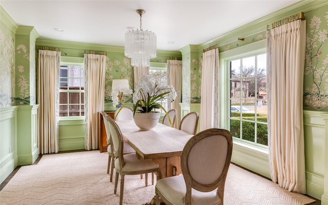 dining space with a healthy amount of sunlight, wallpapered walls, and an inviting chandelier