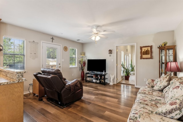 1579 County Road 2008 Unit F, Glen Rose, TX 76043 - living room with a ceiling fan, visible vents, dark wood-style flooring, and baseboards