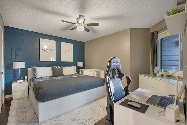 bedroom with a textured wall, a textured ceiling, baseboards, and ceiling fan