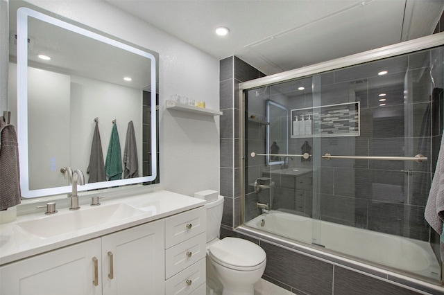 full bathroom featuring tiled shower / bath combo, toilet, and vanity