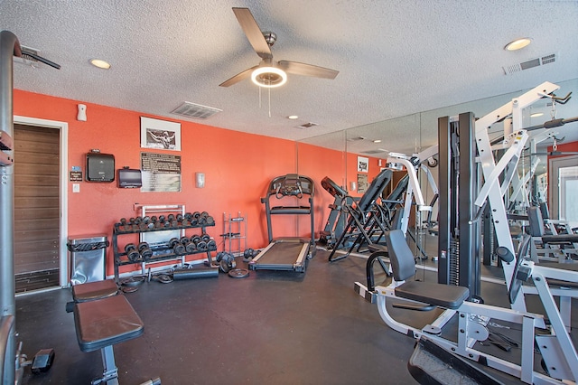 gym featuring a ceiling fan, visible vents, and a textured ceiling