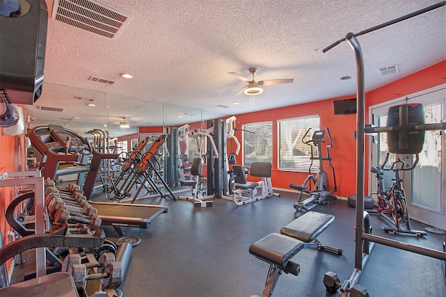 workout area featuring visible vents, ceiling fan, and a textured ceiling