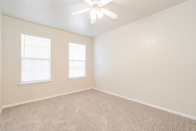 spare room featuring ceiling fan, carpet flooring, and baseboards