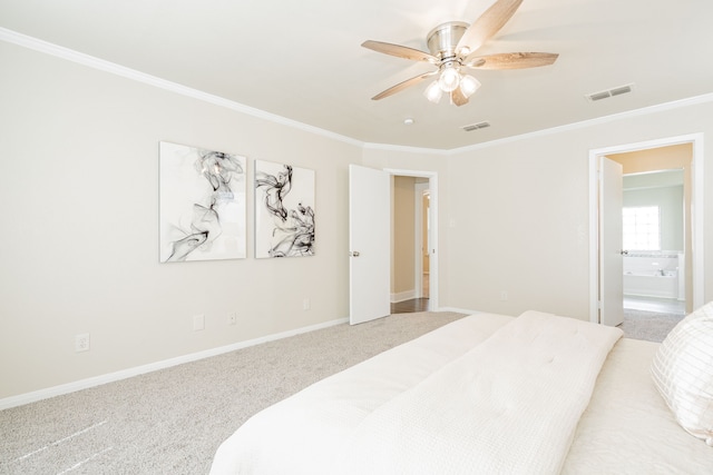 carpeted bedroom featuring visible vents, crown molding, baseboards, and ensuite bathroom