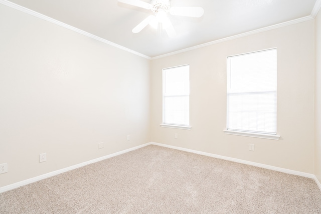 empty room with baseboards, a ceiling fan, crown molding, and carpet flooring