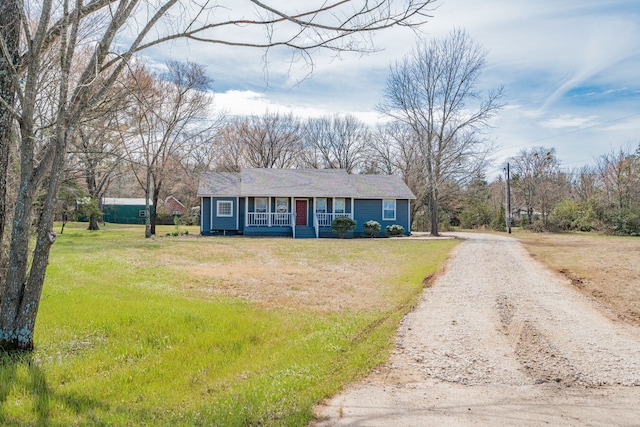 single story home featuring a front yard, covered porch, and driveway