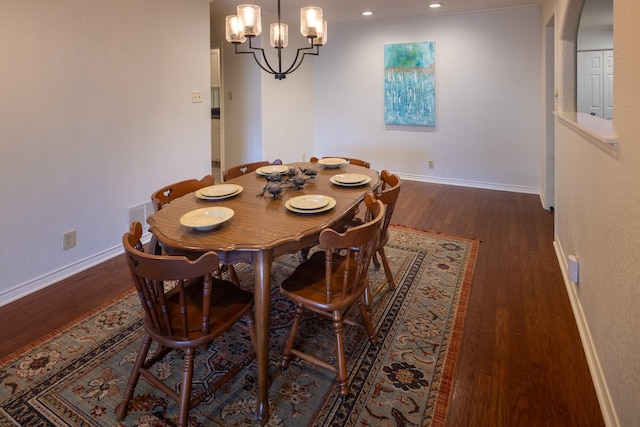 dining space featuring a notable chandelier, recessed lighting, wood finished floors, visible vents, and baseboards