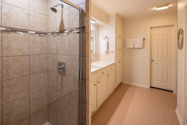 full bath featuring ornamental molding, a stall shower, vanity, and baseboards