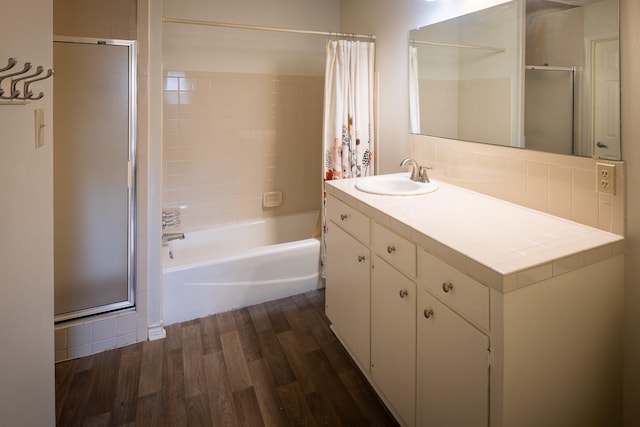 full bathroom with shower / tub combo with curtain, backsplash, wood finished floors, and vanity