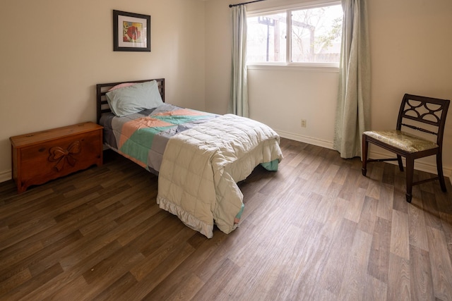 bedroom featuring dark wood-style flooring and baseboards