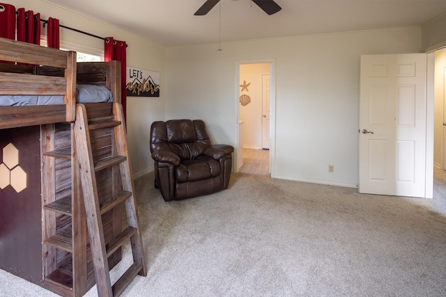 bedroom featuring carpet, baseboards, ceiling fan, and crown molding