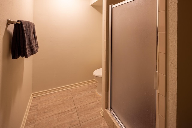 full bathroom with a stall shower, baseboards, and tile patterned floors