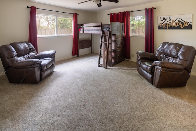 carpeted bedroom featuring a ceiling fan and baseboards