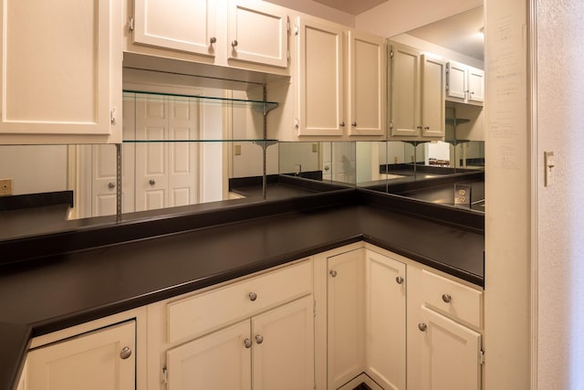 kitchen with dark countertops and white cabinets