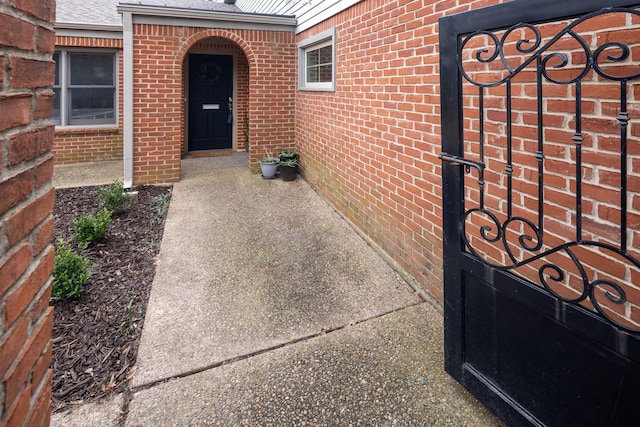 property entrance featuring brick siding