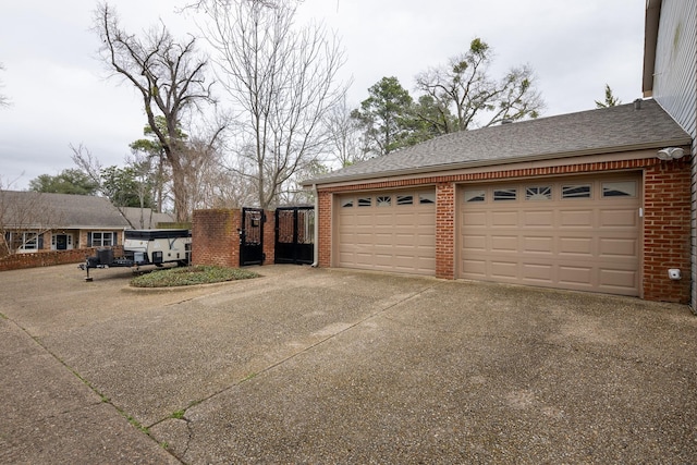 garage featuring concrete driveway