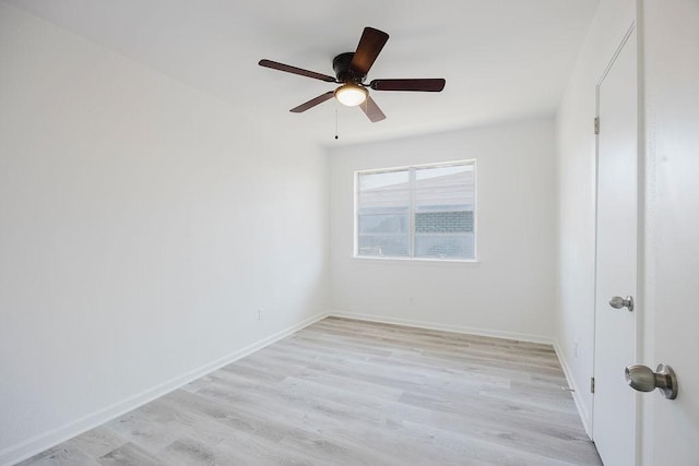 unfurnished room with a ceiling fan, light wood-style flooring, and baseboards