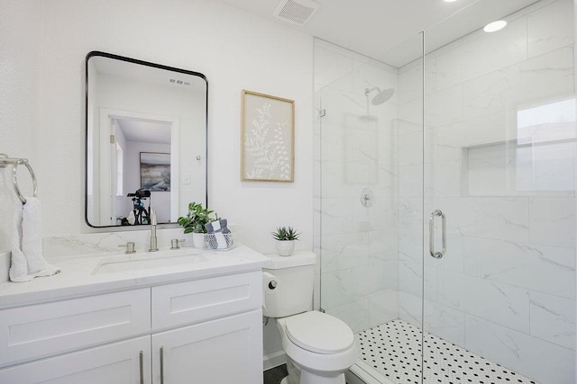 full bathroom with toilet, a stall shower, vanity, and visible vents