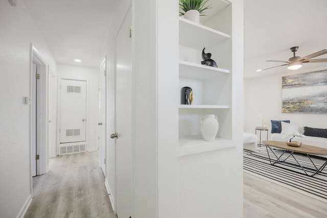 corridor featuring visible vents and light wood-style flooring