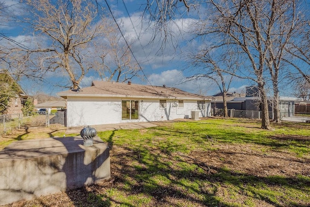 exterior space featuring brick siding, fence, and a front yard