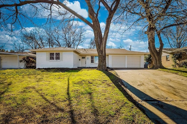 ranch-style home with driveway, a front lawn, an attached garage, and brick siding