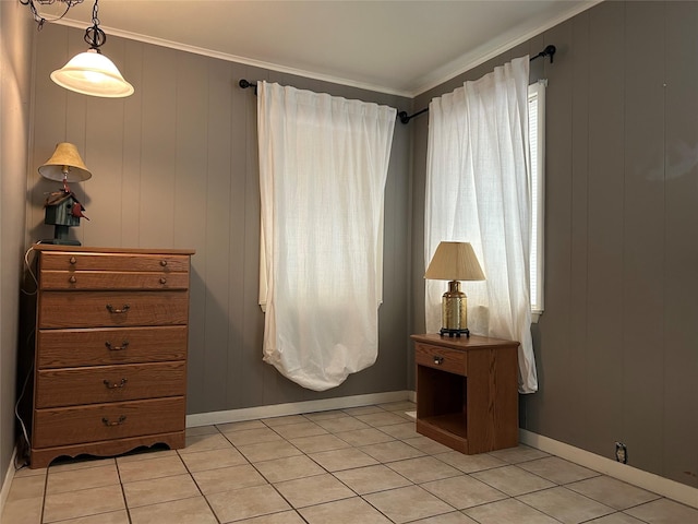 interior space featuring ornamental molding, light tile patterned flooring, and baseboards