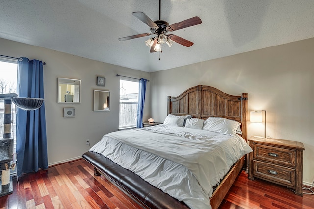 bedroom with a textured ceiling, a ceiling fan, and wood finished floors