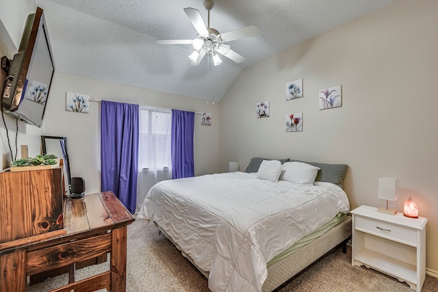 carpeted bedroom featuring lofted ceiling, ceiling fan, and a textured ceiling