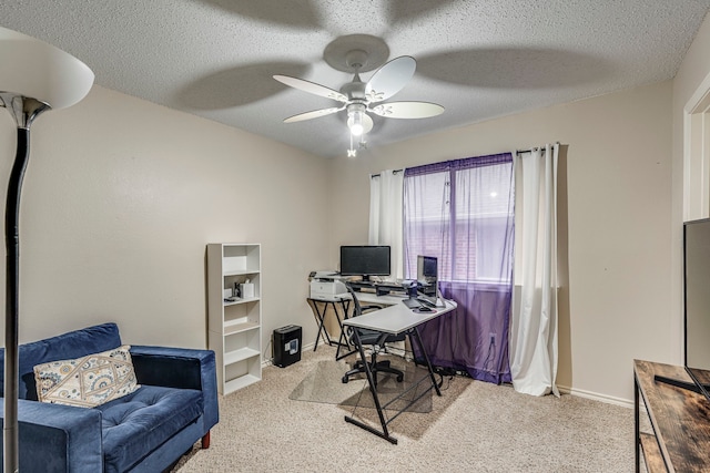 home office with ceiling fan, a textured ceiling, baseboards, and carpet flooring