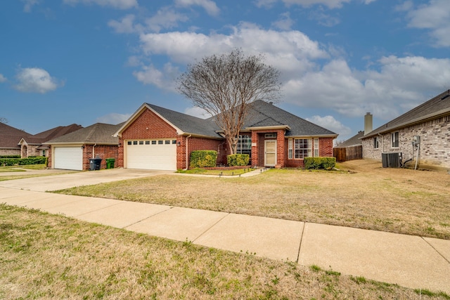 view of front facade featuring a garage, driveway, brick siding, central AC unit, and a front yard