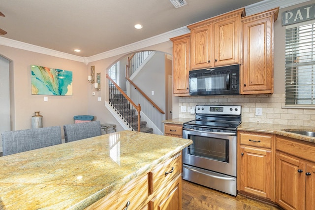 kitchen featuring decorative backsplash, ornamental molding, stainless steel range with electric cooktop, light wood-type flooring, and black microwave