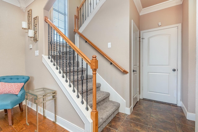 stairway featuring ornamental molding and baseboards