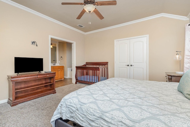 bedroom featuring a closet, visible vents, and crown molding