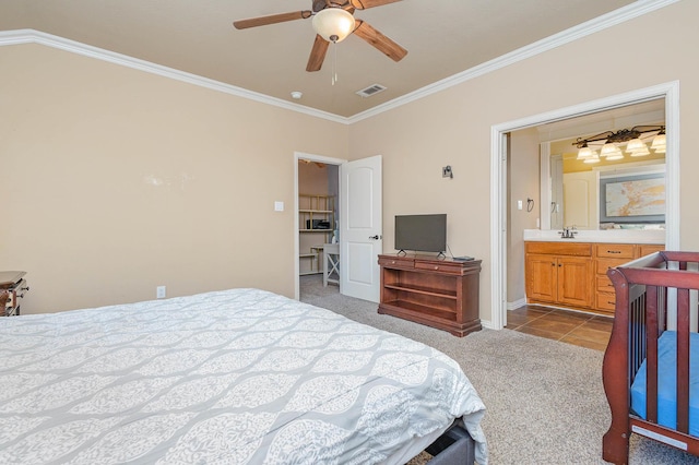 bedroom with visible vents, dark tile patterned flooring, ensuite bath, crown molding, and dark carpet