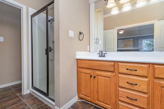 full bathroom with tile patterned flooring, a shower stall, vanity, and baseboards