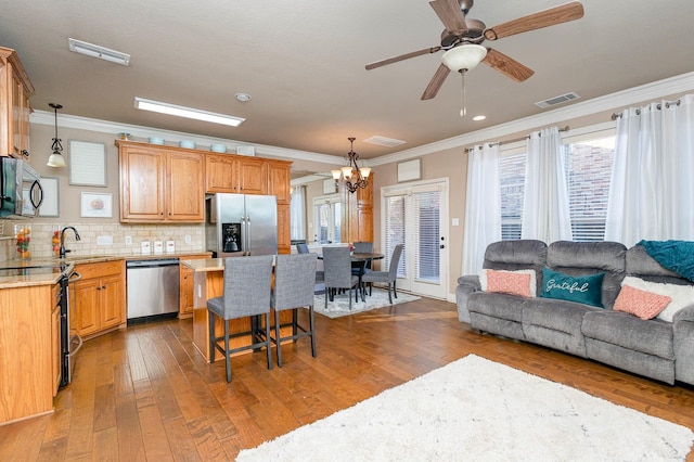 kitchen with stainless steel appliances, dark wood-style flooring, visible vents, and backsplash