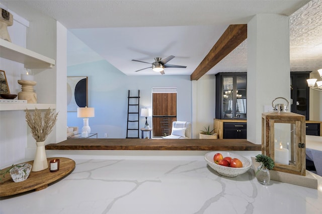 living room featuring beam ceiling and a ceiling fan