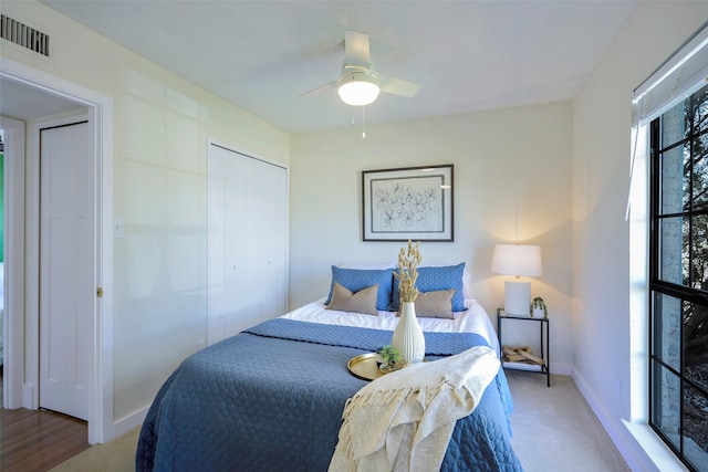 bedroom with visible vents, ceiling fan, baseboards, carpet floors, and a closet