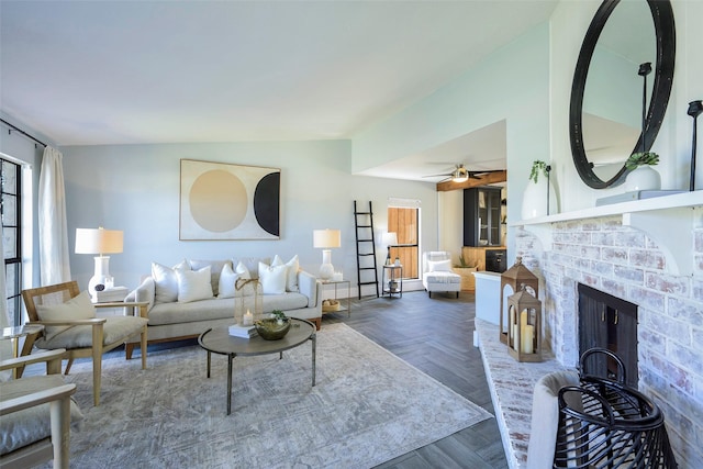 living area with a fireplace and ceiling fan