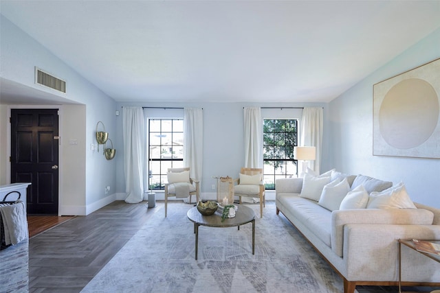 living area with baseboards, visible vents, and a wealth of natural light