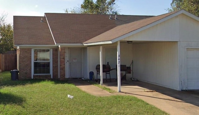 view of front of property with a garage, a front lawn, and roof with shingles