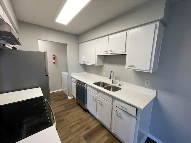 kitchen with white cabinets, dark wood-style floors, stainless steel appliances, light countertops, and a sink