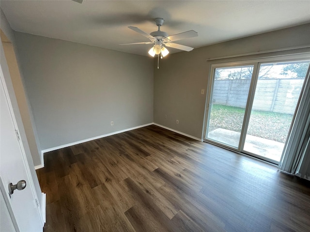 empty room with ceiling fan, dark wood finished floors, and baseboards