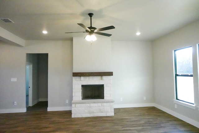 unfurnished living room featuring recessed lighting, visible vents, a stone fireplace, wood finished floors, and baseboards