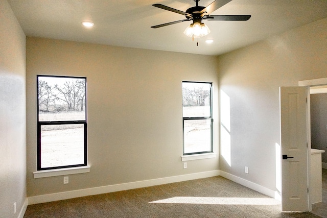 carpeted empty room with recessed lighting, a healthy amount of sunlight, ceiling fan, and baseboards