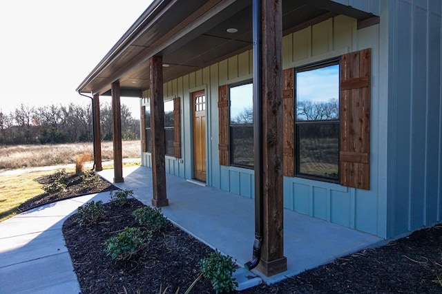 view of side of home with board and batten siding and a porch