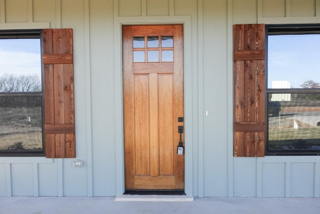 doorway to property featuring board and batten siding