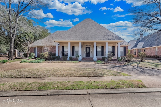 101 Chesterton Ct, Bossier City, LA 71111 - view of front of property with covered porch, brick siding, and roof with shingles