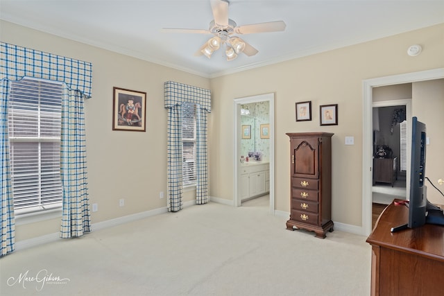 bedroom featuring ornamental molding, light colored carpet, ensuite bath, and baseboards