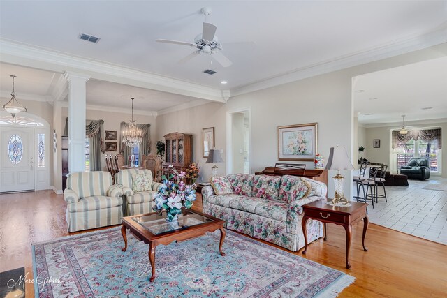 101 Chesterton Ct, Bossier City, LA 71111 - living area with wood finished floors, a ceiling fan, decorative columns, a chandelier, and ornamental molding